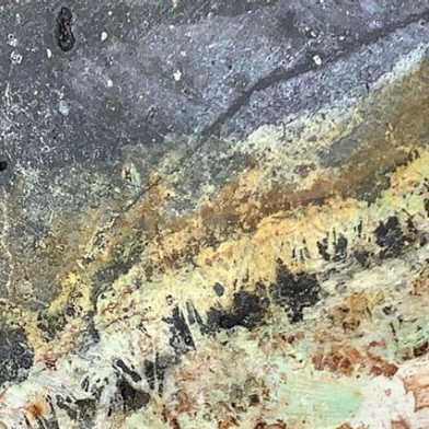 Hydrothermally altered rock with copper and gold mineralization.